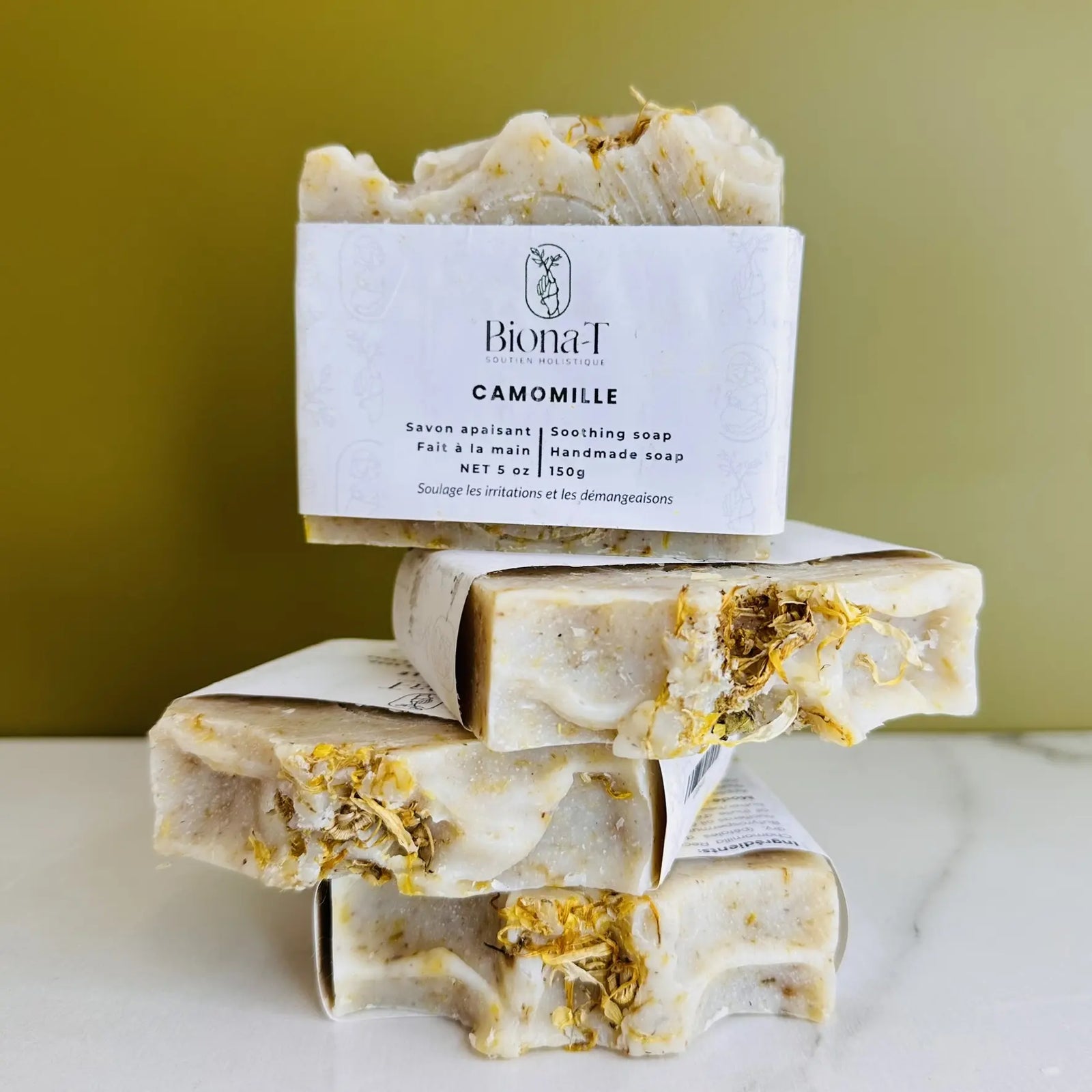 savon artisanal Biona-T è la camomille pour visage, corps et peau sèche, posé sur une table